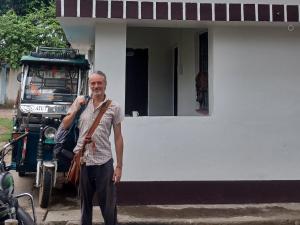 a man standing in front of a house at Dharmik guest house in Bodh Gaya