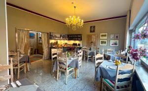 a restaurant with tables and chairs and a chandelier at Hotel Am Sportpark in Duisburg