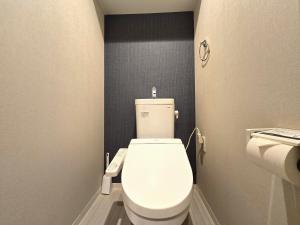 a bathroom with a white toilet in a room at Comfort CUBE PHOENIX Yakuin in Susakiuramachi +3 photos