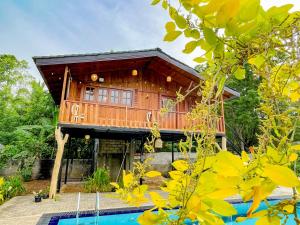 a tree house with a pool in front of it at Sigiriya Elegant Resort in Sigiriya