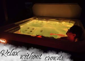 a woman in a jacuzzi in a bath tub at AGAMI T in Pavčina Lehota