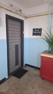 a black garage door with a sign on a wall at Casita in Vaslui