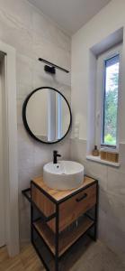 a bathroom with a sink and a mirror at Mazury Lake House Jerutki in Jerutki +39 photos