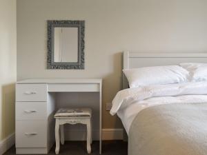 a bedroom with a bed and a table with a mirror at Five Dorchester Drive - Uk32043 in Inglewhite
