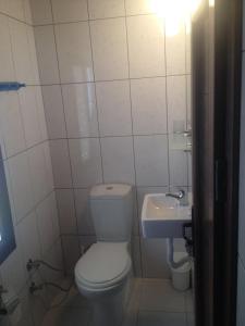 a bathroom with a toilet and a sink at Kalipso motel in Çeşme