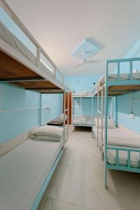 a room with two bunk beds and a hallway at Explore Hostel Life Jaisalmer in Jaisalmer