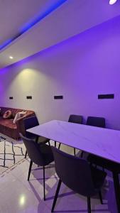 a room with a table and chairs and a bed at Sky2030Group in Dammam +136 photos