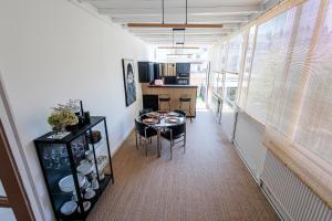 a kitchen and dining room with a table and chairs at Du sable dans les chaussures in Dunkerque