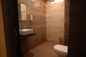 a bathroom with a white toilet and a sink at Hotel Galaxy Inn !! 5 Min From Nemcare Hospital !! in Guwahati