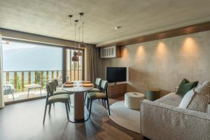 a living room with a couch and a table at Alea Living in Tirolo