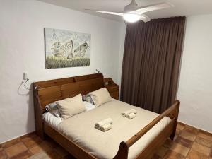a bedroom with a bed with two pillows on it at Isabel2 in Famara