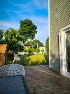 a porch with a chair and a view of a yard at Fully equipped new tiny-house in Kuressaare
