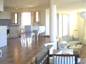 a kitchen and living room with a table and chairs at Villa Rotunda in Alonissos Old Town in Alonnisos