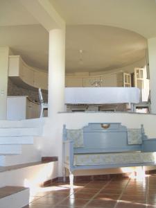 a kitchen with a blue bench in a room at Villa Rotunda in Alonissos Old Town in Alonnisos