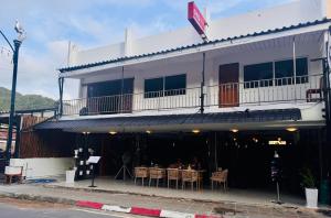 a white building with a table in front of it at SET INN restaurant & bar 1 & 2 in Kata Beach