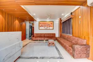 a living room with a couch and a table at My Bizz Hotel Celebration Chakan in Chakan