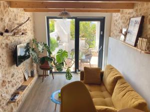 a living room with a couch and a large window at AltHouse Canet lo Roig in Canet lo Roig