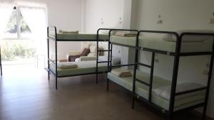 A bed or beds in a room at Albergue O Trisquel
