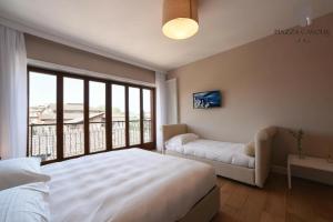 a bedroom with a bed and a large window at B&B Piazza Cavour in Rieti