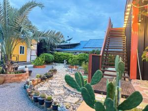 a garden with a lot of cacti and plants at บ้านอินทผลัม รีสอร์ท in Ban Na Lao