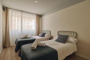 En eller flere senge i et værelse på Apartamentos Atlantis