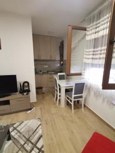 a kitchen with a table and chairs in a room at apartmani Daria in Cetinje +4 photos
