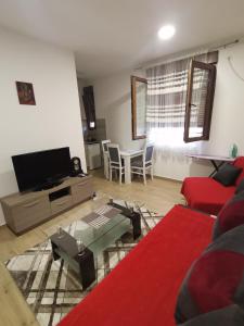 a living room with a couch and a table at apartmani Daria in Cetinje