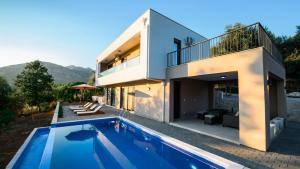 a house with a swimming pool next to a house at Villa Amara -Luxury Villa with Private Pool & Hot Tub in Bar