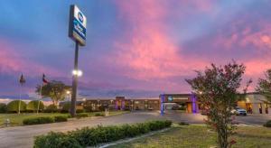 a gas station with a sign in a parking lot at Best Western Taylor Inn in Taylor