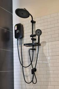 a shower head on a wall in a bathroom at De Helga Apartment Chaloklum in Ko Phangan +9 photos