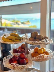 three tiers of fruit on plates with bananas and apples at Greif Hotel & Spa in Trieste