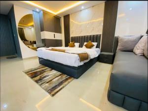 a bedroom with a large bed and a couch at The Haven Suite in Dehradun