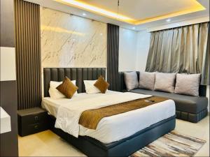 a bedroom with a bed and a couch at The Haven Studio in Dehradun