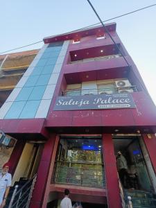 a building with a santa ana palace sign on it at Saluja Palace in Rāe Bareli
