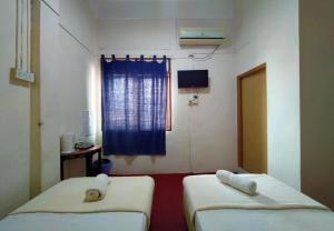 Postel nebo postele na pokoji v ubytování Rz Gold Hotel Official Account