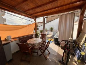 a patio with a table and chairs and a bike at Apt Versilia in Viareggio