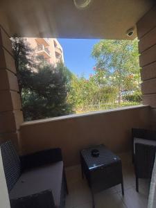 a window in a room with a bench and a table at Dawn Park Deluxe in Sunny Beach