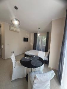 a living room with a table and chairs and a bed at Dawn Park Deluxe in Sunny Beach +133 photos