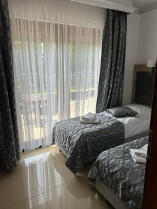 sypialnia z dwoma łóżkami i oknem w obiekcie Wichrowe Wzgórze Chmielno w Chmielnie