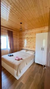 a bedroom with a large bed in a wooden room at Luna di Mare in Ureki
