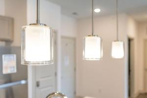 three lights hanging from the ceiling in a kitchen at Affordable Private Room in Whitestown +24 photos