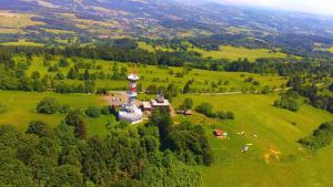 an aerial view of a building with a clock tower in a field at Riegrova Chata Kozákov in Semily
