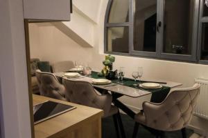 a dining room with a table and chairs with glasses at Om relax in Prijedor