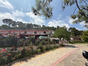 a train on a bridge over a garden with flowers at Hotel The Premium Villa Himalaya Hill in Kūd