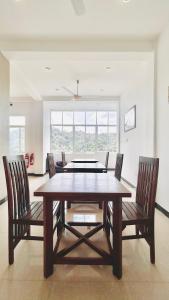 a dining room with a wooden table and chairs at Terrace Kandy in Kandy