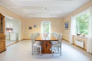 a dining room with a wooden table and chairs at Croftholmen bolig, Stathelle in Stathelle