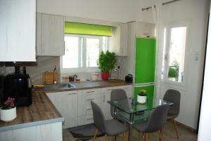 a kitchen with a table and a green refrigerator at Chalkida near Castle in Kánithos