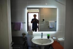 a man taking a picture of himself in a bathroom mirror at Chalkida near Castle in Kánithos +28 photos