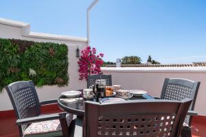 a table and chairs sitting on a patio at Tetuan 43 - Oasis Properties in Nerja