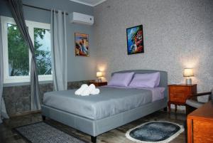 a bedroom with a bed with purple pillows at Chalkida near Castle in Kánithos